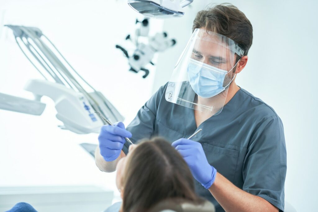 Male dentist and woman in dentist office